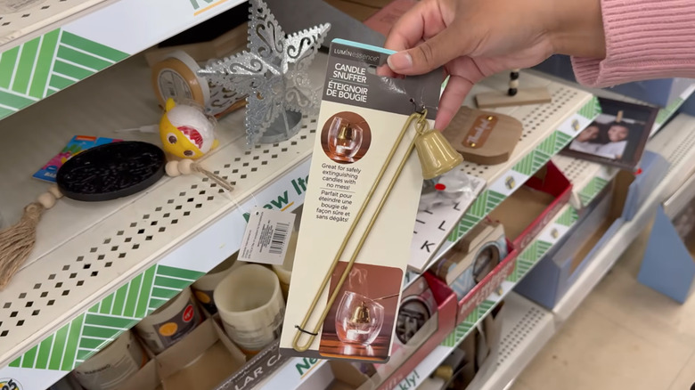 Woman holding new candle snuffer in store