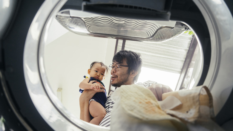 man taking laundry out of machine