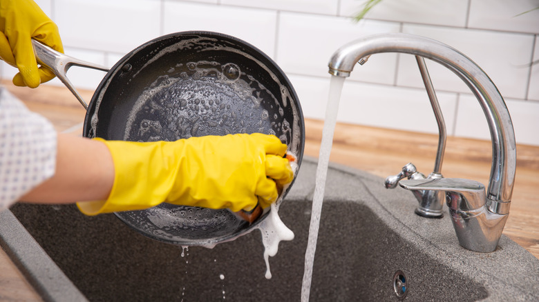 hands washing ceramic pan