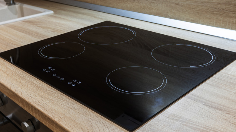 glass top stove on wood counter