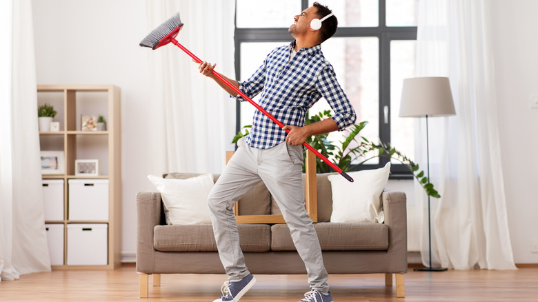 Man dancing with broom