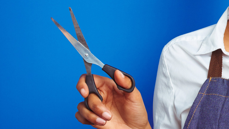 woman holding scissors
