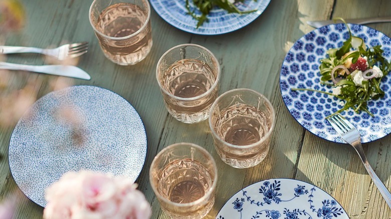 ENTUSIASM side plates on dinner table with food and drinks
