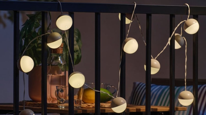 SOLVINDEN LED string light wrapped around fence