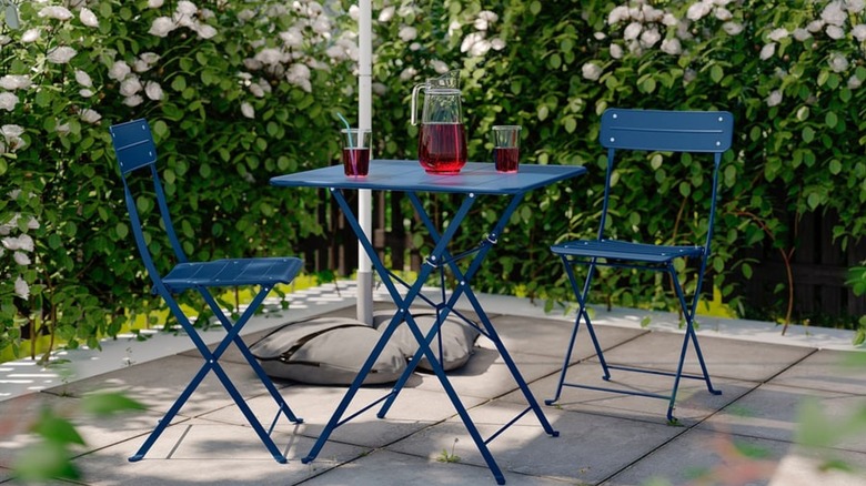 IKEA dark blue folding bistro table and chairs in courtyard