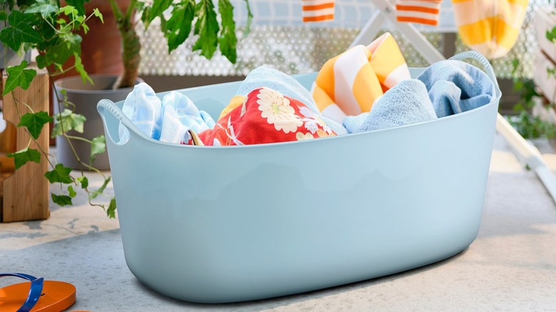 IKEA indoor/outdoor laundry basket filled with towels