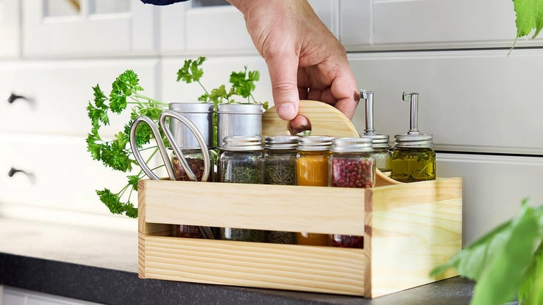 Taking a portable organizer filled with spices and oils and herbs
