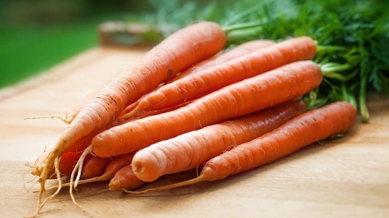 Pile of carrots on a wooden table