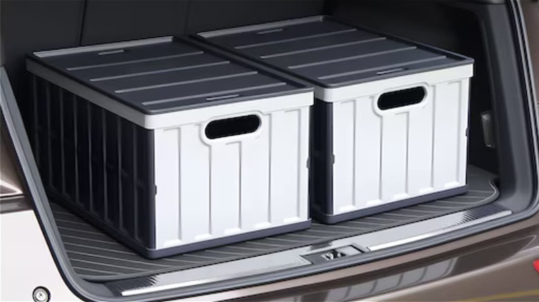 Two GIVIMO collapsible storage bins with lids in the trunk of a car