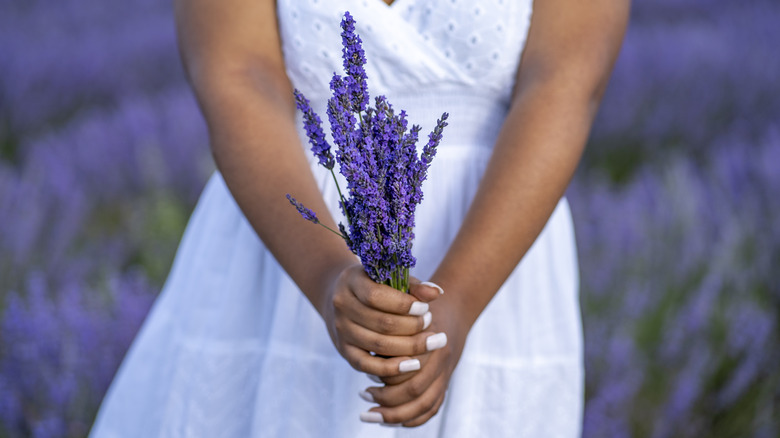 A woman holding a bouquet of lavender