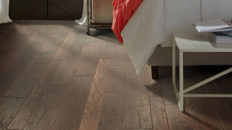 dark mixed-width flooring in bedroom