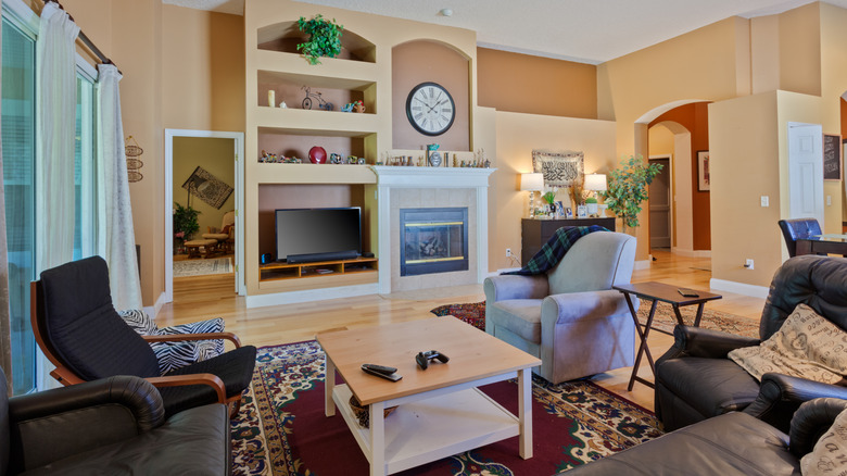 A living room arranged with multiple chairs and tables