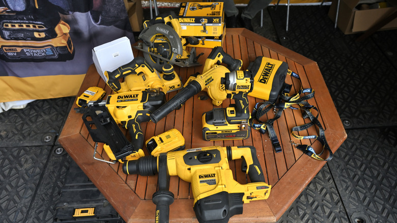 A selection of DeWalt tools laid out on a wooden table