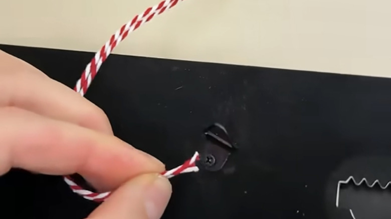 Hand demonstrating string trick