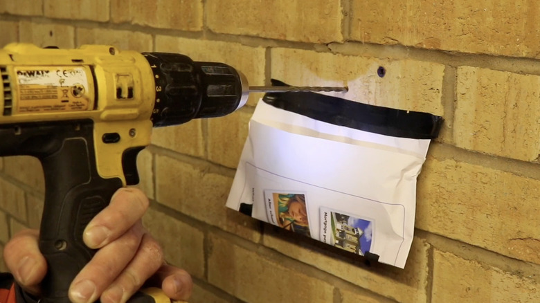 Drilling hole with paper catching dust