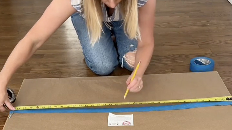Woman demonstrating painter's tape hack