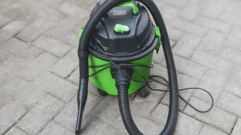 A green and black wet-dry vacuum.