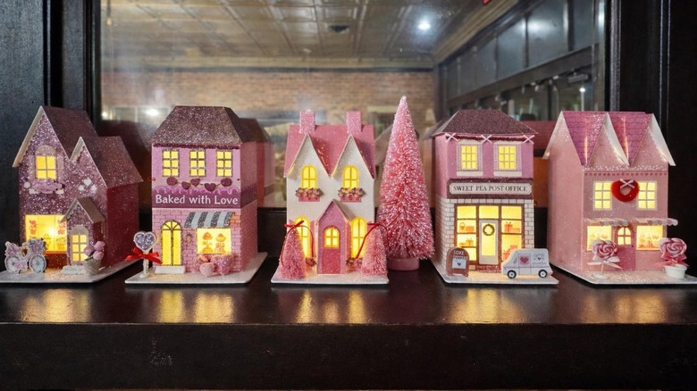 Five sparkley pink paper houses decorated for Valentine's day