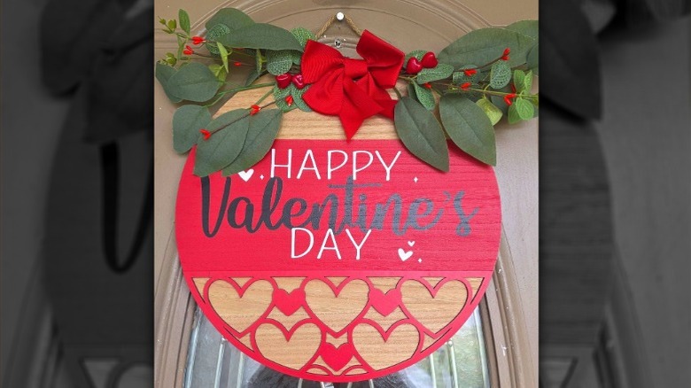 A red Valentine's Day door sign made of wood
