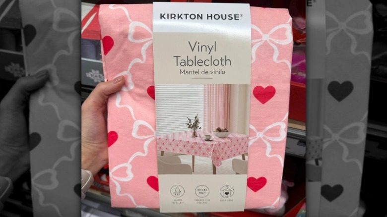 A pink tablecloth with heart and bow designs