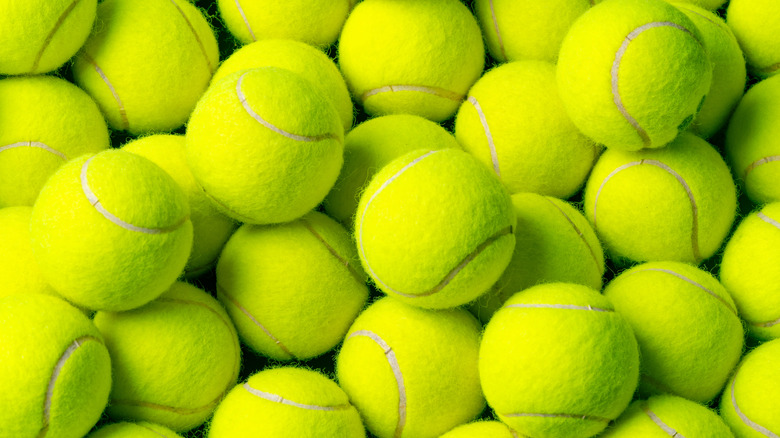 A pile of bright yellow tennis balls