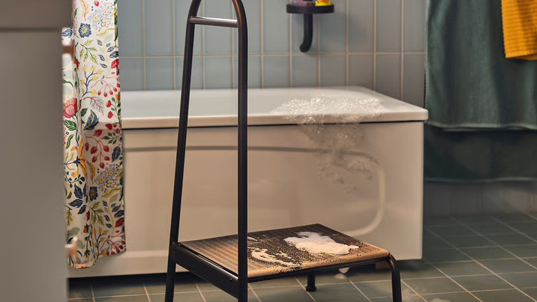 Modern IKEA step stool with a water spill and bath bubbles