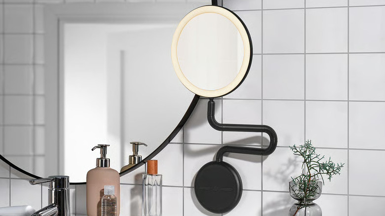 Modern IKEA mirror with ring light and adjustable base on tiled bathroom wall