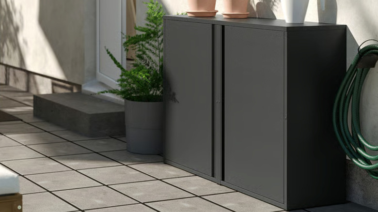 IKEA SUNDSÖ Cabinet on a patio with plant pots on top.