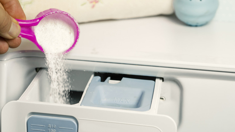 Pouring borax into a washing machine