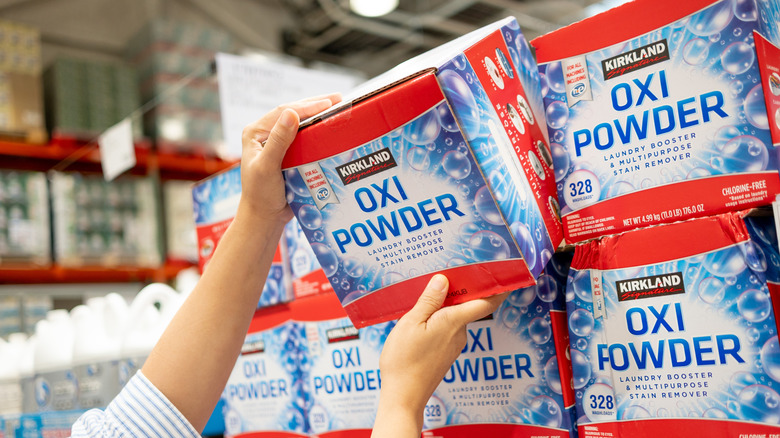 Person picking up oxygen powder from Costco shelf