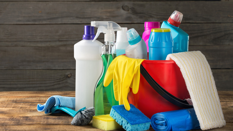 assorted cleaning supplies in a bucket