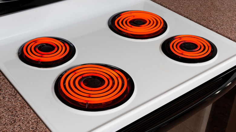 Electric coil stove with burners on high heat