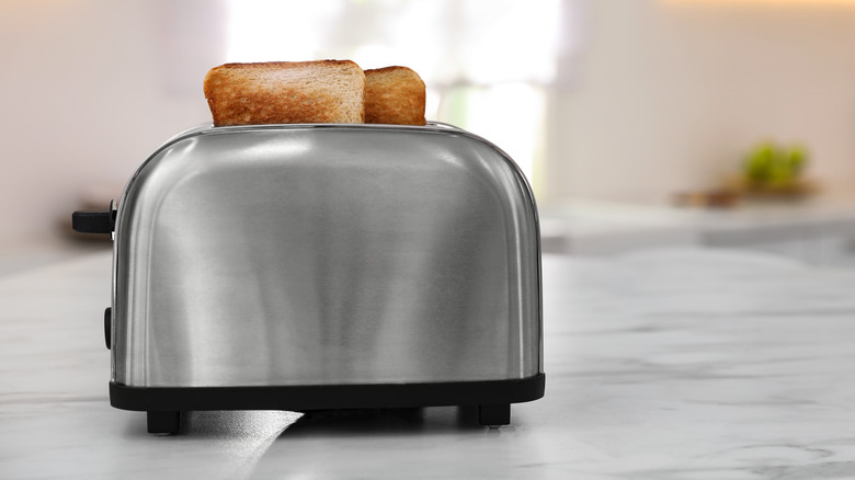 Toaster on a countertop with popped toast
