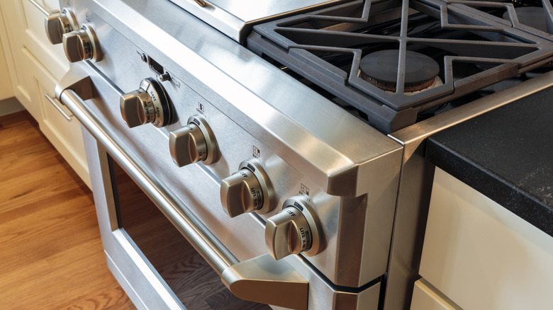 A stainless steel gas range with an oven.