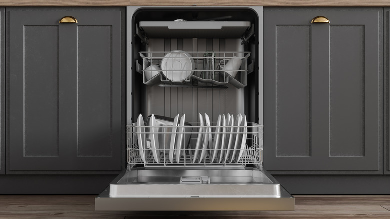 An open dishwasher with dishes stacked inside it.