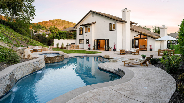 A house with a large pool and hot tub