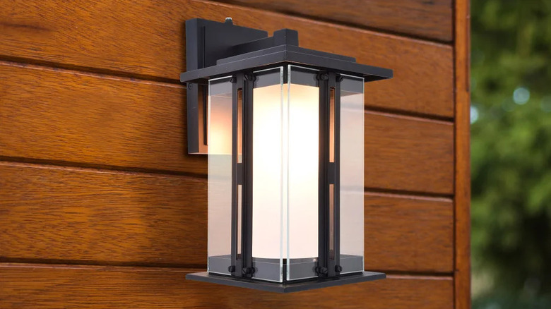 A Lutec Outdoor LED Wall Lantern on the side of a house