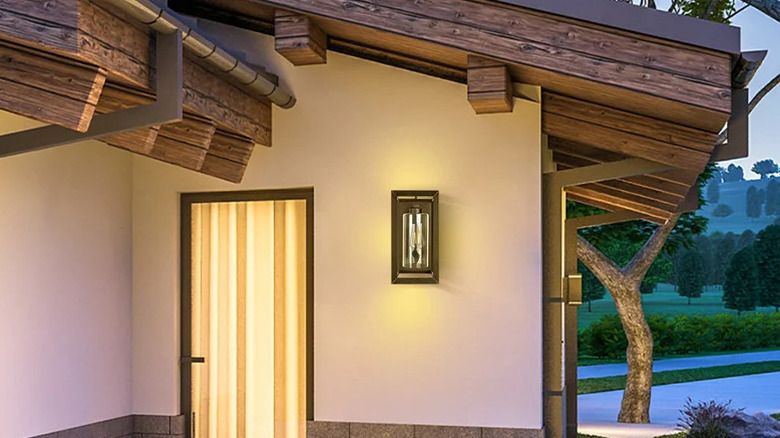 A Feit Electric LED Coach Lantern on the side of a house