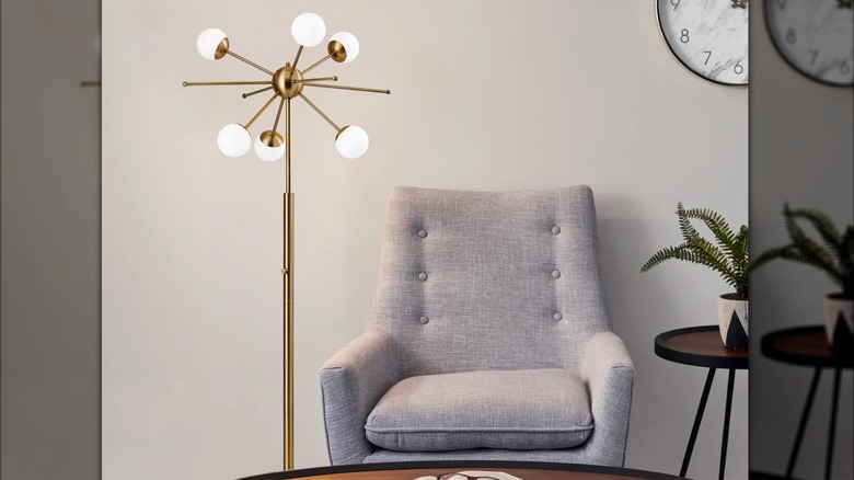 A Nash Floor Lamp by a gray chair