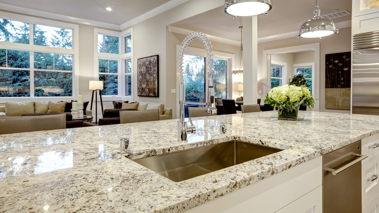 closeup on a granite kitchen counter top with two pendant lights above