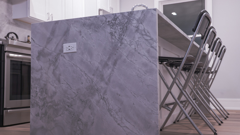 waterfall island made of quartzite in kitchen