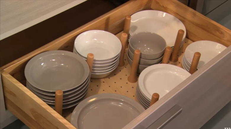 A kitchen drawer with a pegboard for organization
