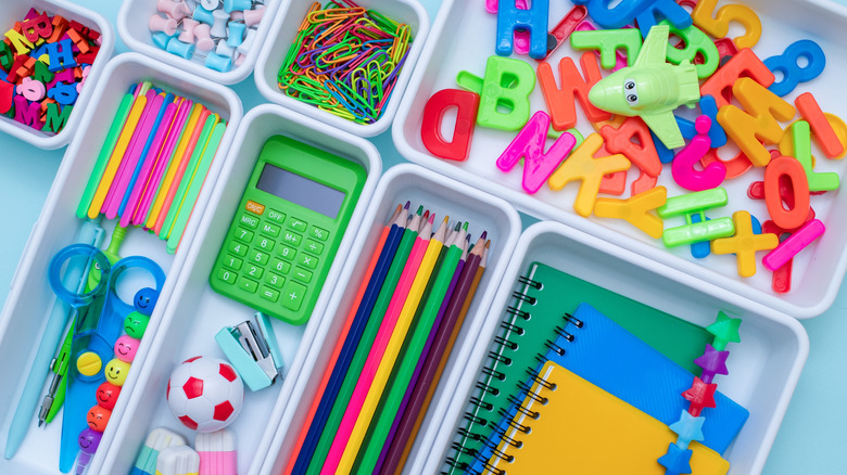 School supplies and small toys in individual trays