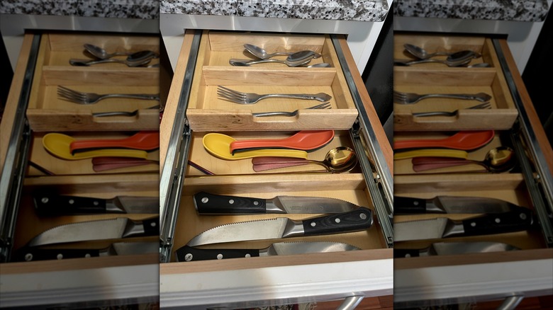 A cutlery drawer with tiered divider