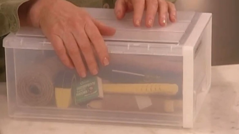 Clear container with tools and supplies in it