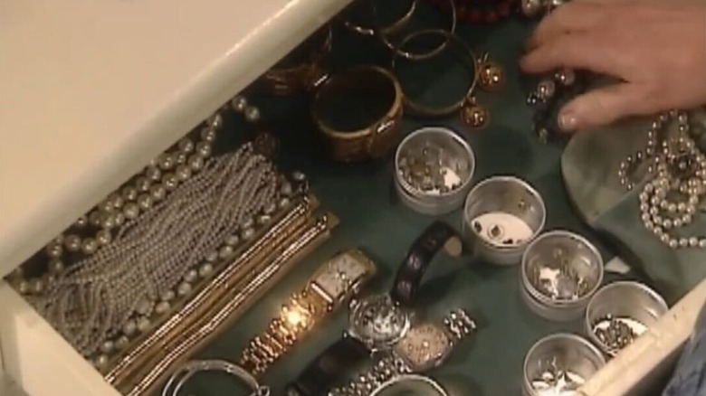 A jewelry drawer with small tins for organizing