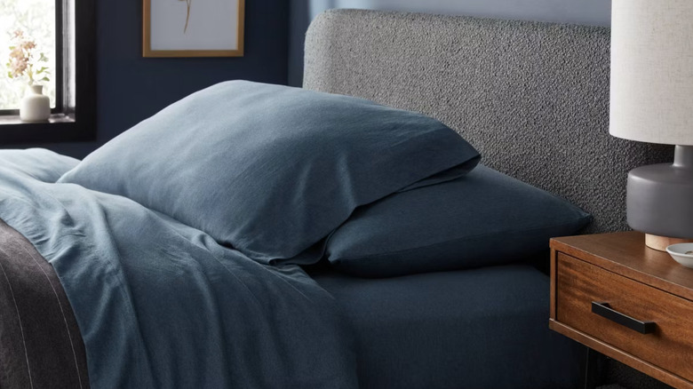 Target Threshold blue jersey cotton sheets on a bed with decor in the background