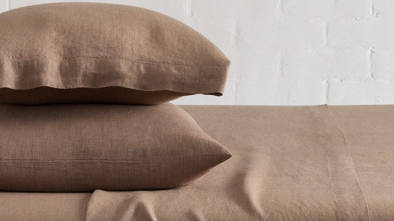 West Elm European Flax Linen Sheet and Pillowcases against a white brick wall