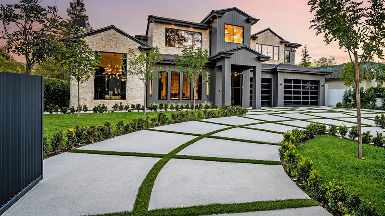Home with concrete pavers and turf driveway