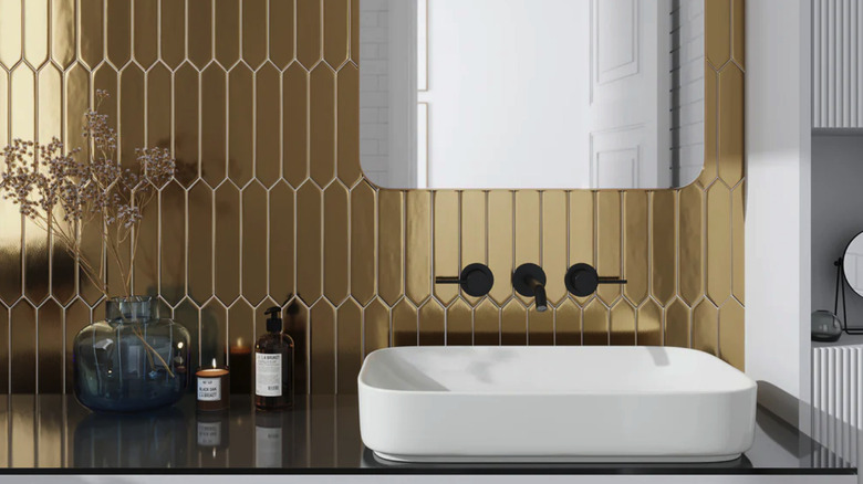 Gold elongated hexagon tiled wall with a modern vanity